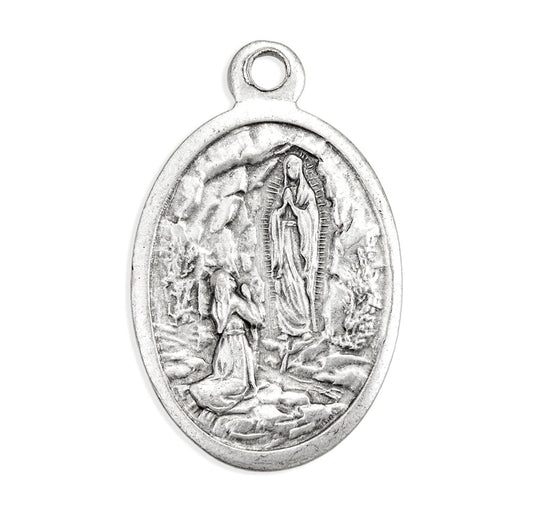 Silver pendant with religious design on a white background