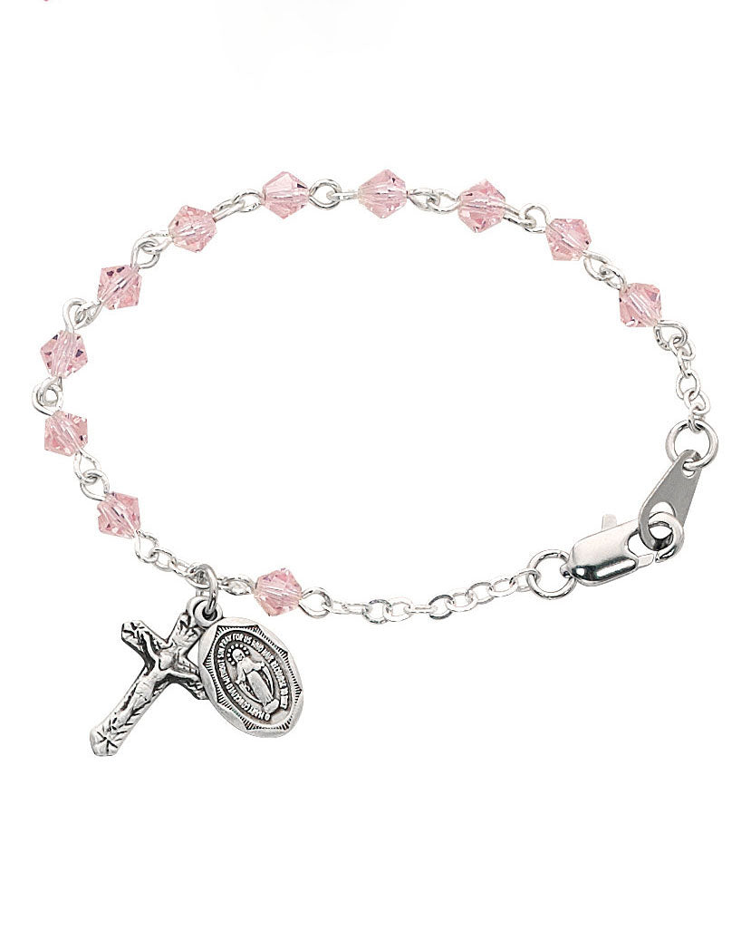 Silver bracelet with pink beads and religious charm on a white background