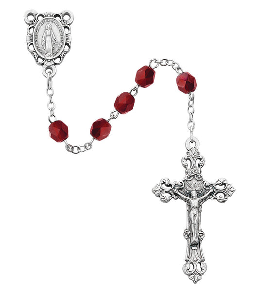 Silver rosary with red beads on a white background