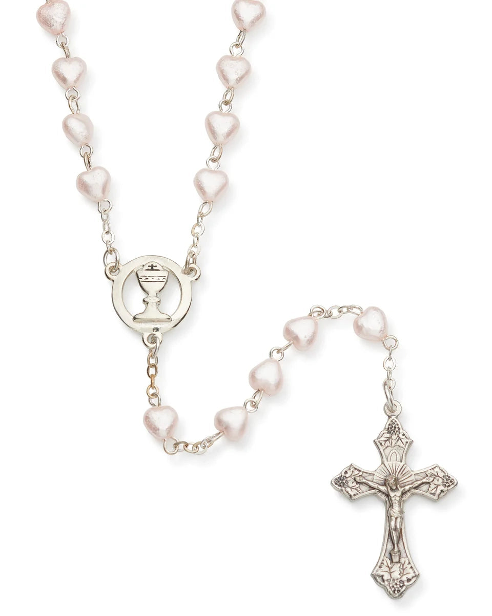 Rosary with pink beads and a silver cross on a white background