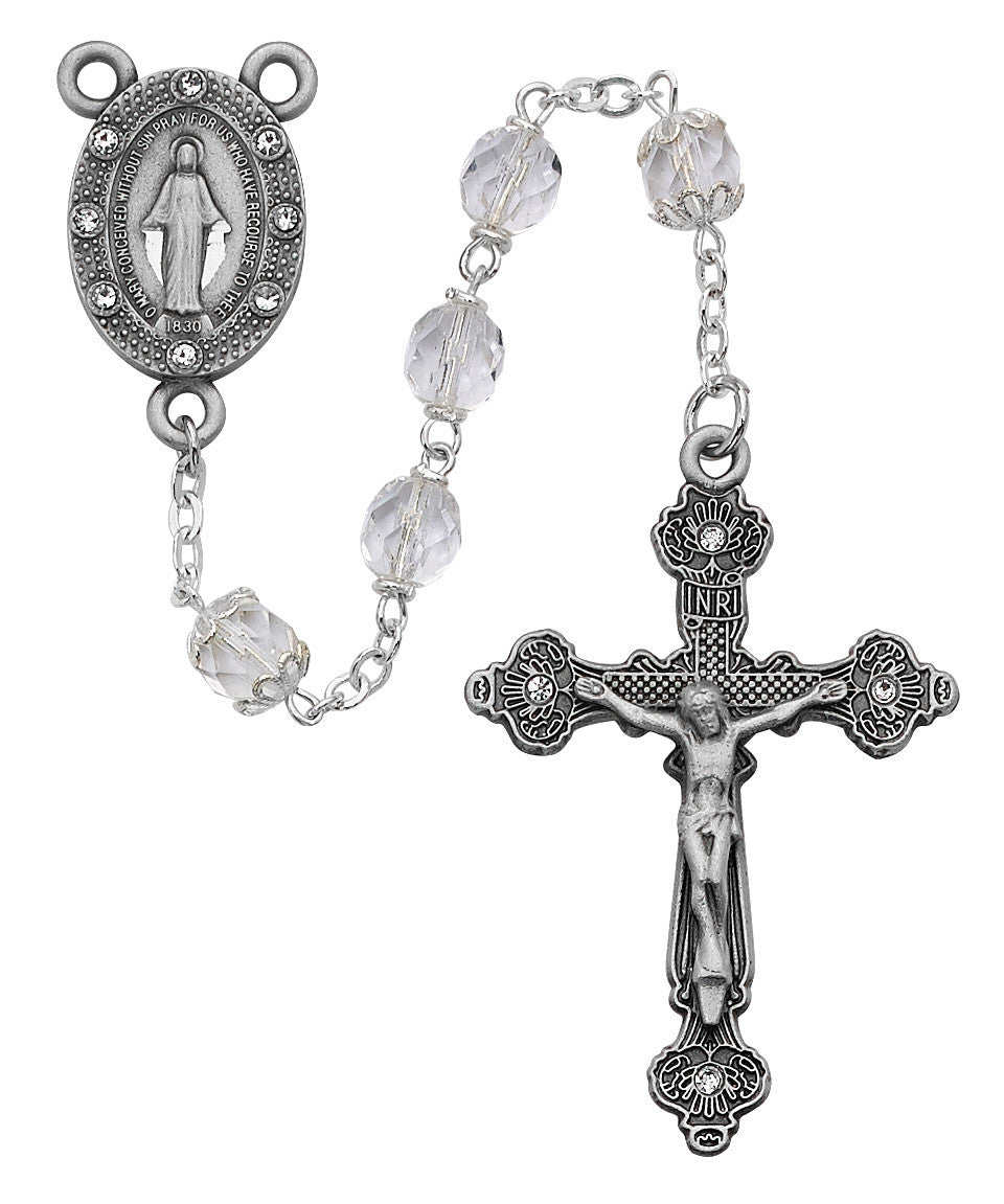 Silver rosary with clear beads on a white background