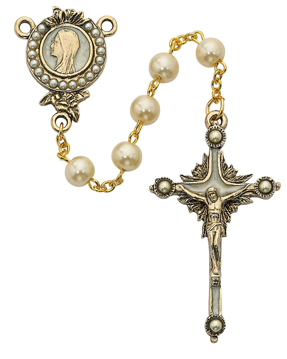 Rosary with pearl beads and a cross on a white background