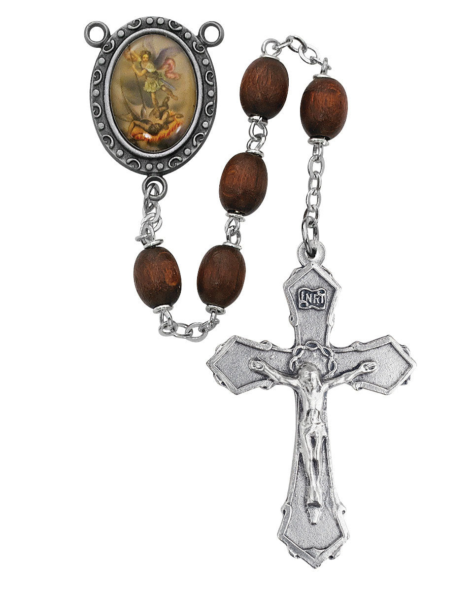 Rosary with wooden beads and silver crucifix on a white background