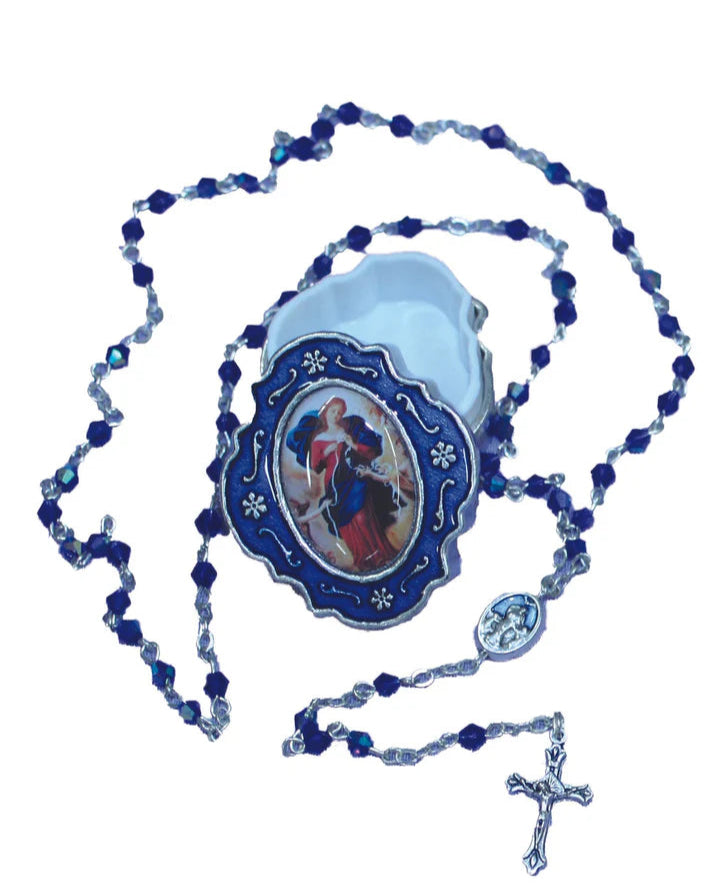 A blue and white Our Lady Undoer of Knots rosary with a enamel box and jewel accents.