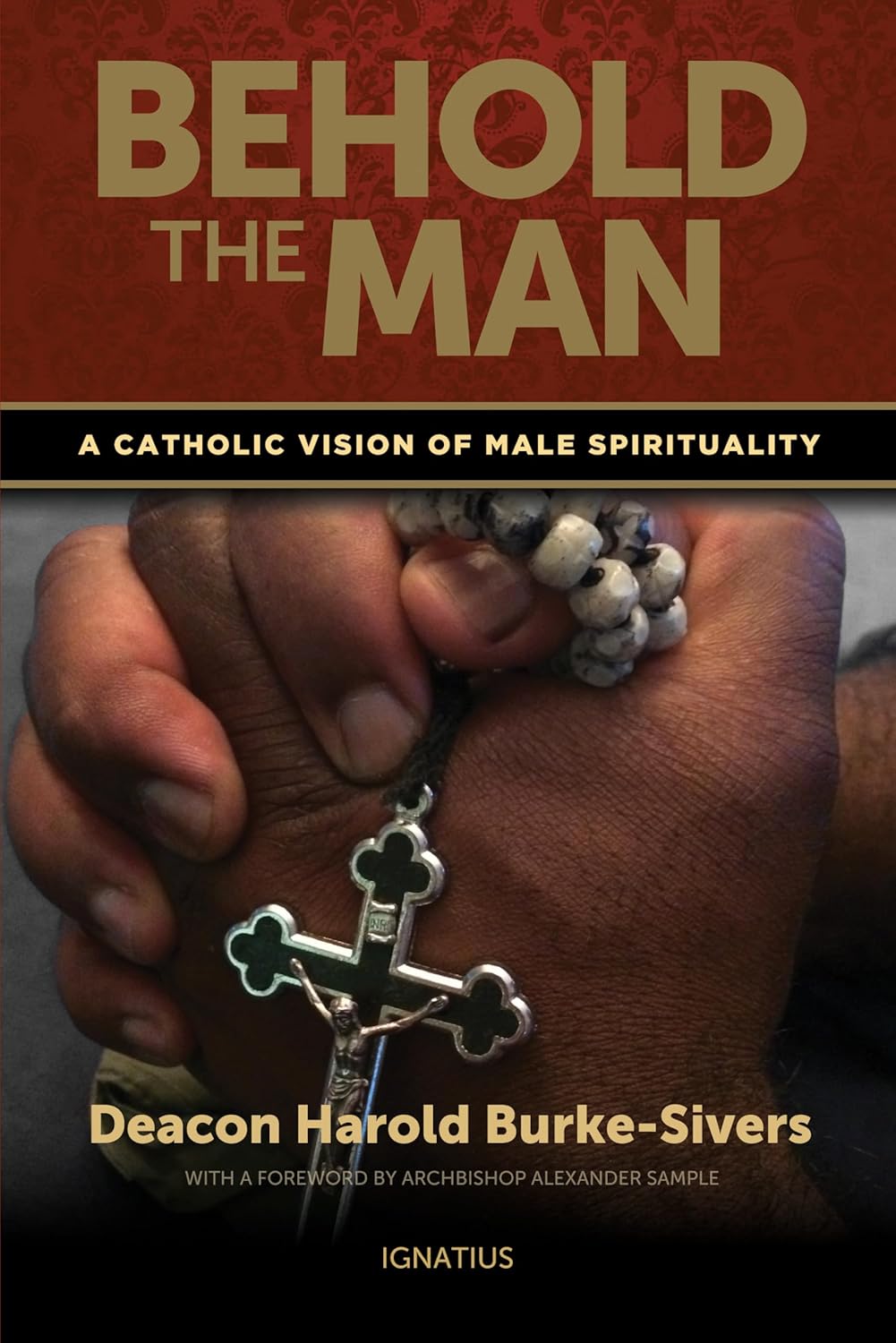 Book cover of 'Behold the Man' with a hand holding a rosary on a dark background
