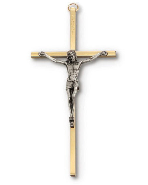 Gold and silver crucifix on a white background