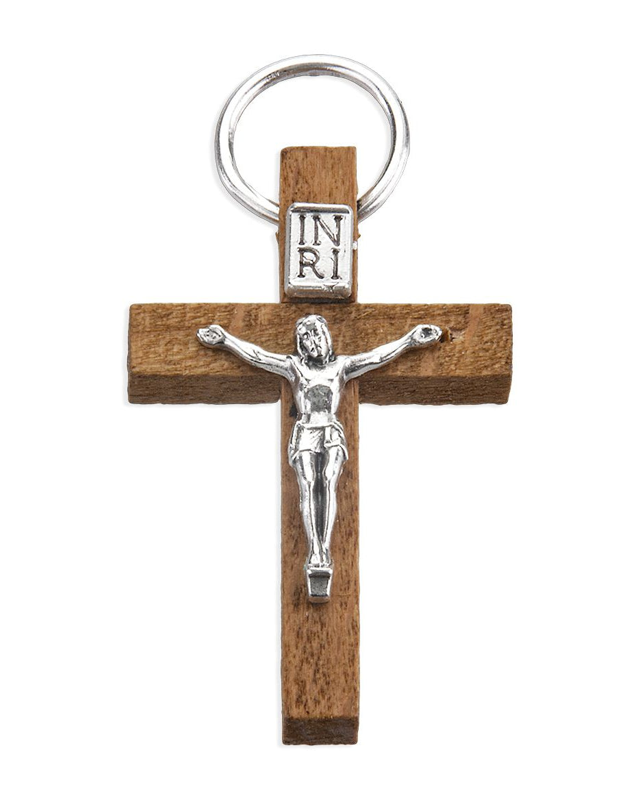 Wooden cross keychain with silver Jesus figure and 'INRI' inscription on a white background