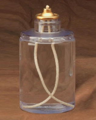 Clear glass bottle with a gold cap on a brown background