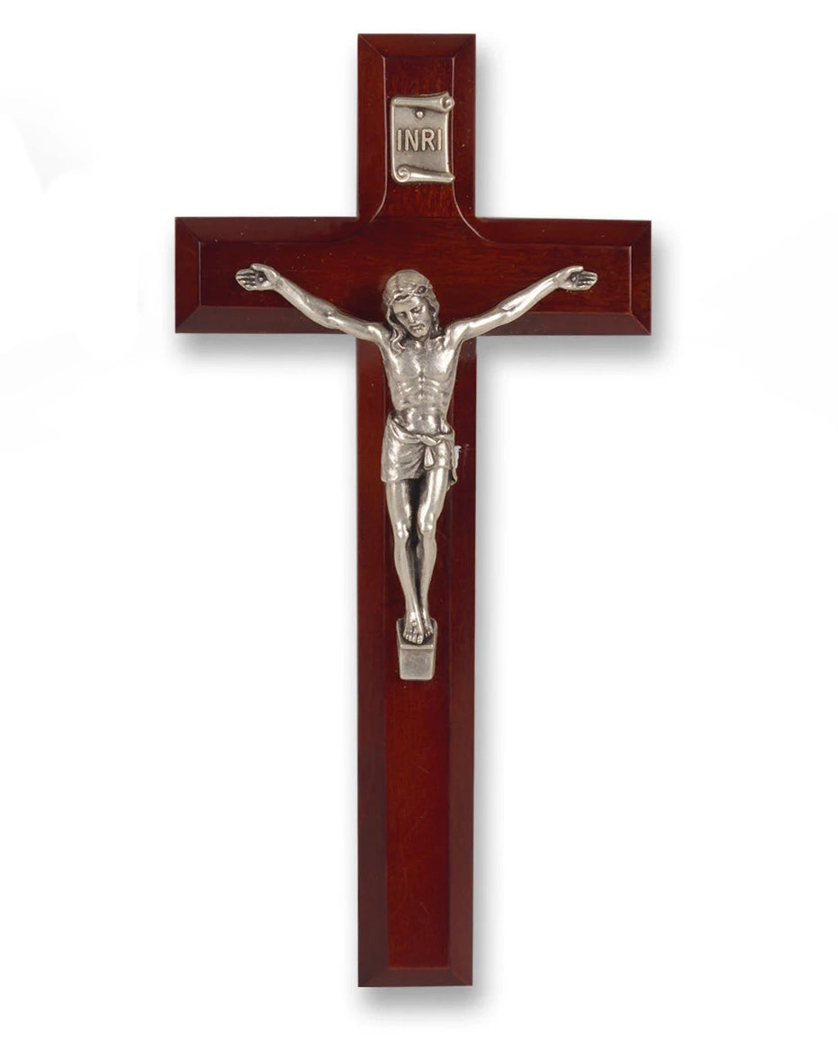Wooden cross with silver Jesus figure on a white background