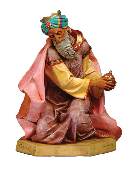 Colorful figurine of a wise man holding a crown on a white background