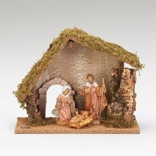 A Fontanini 3 piece nativity set featuring figures of the Holy Family and a stable made of wood, moss, and bark, placed on a flat surface.