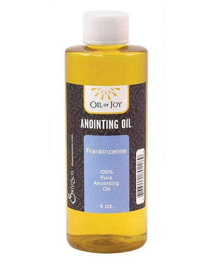 Bottle of anointing oil with a label on a white background