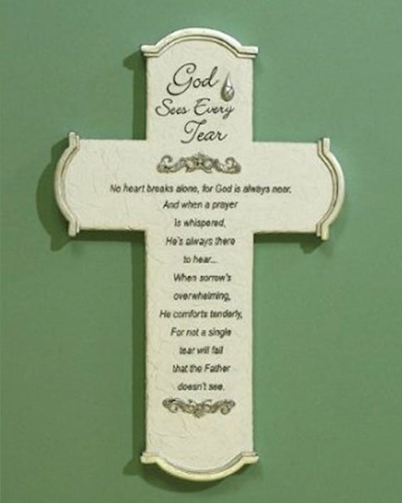 Decorative cross with engraved text on a green background