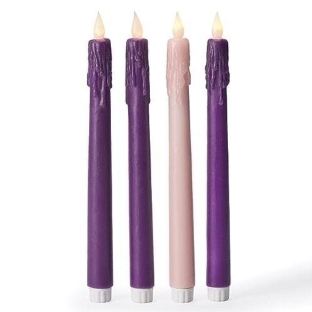 Four purple and pink candles with white bases on a white background