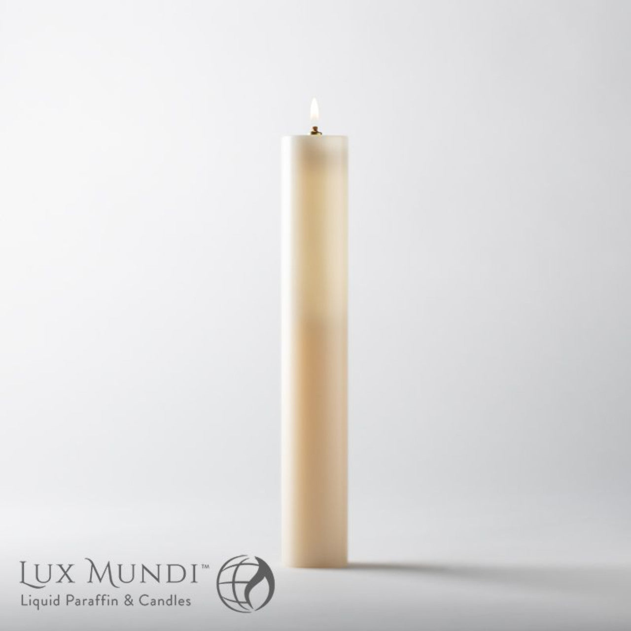 Tall, beige candle with a visible flame on a light gray background, featuring the Lux Mundi brand.
