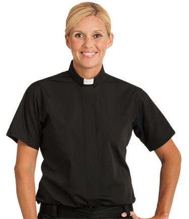 Person wearing a black shirt with a clerical collar on a white background