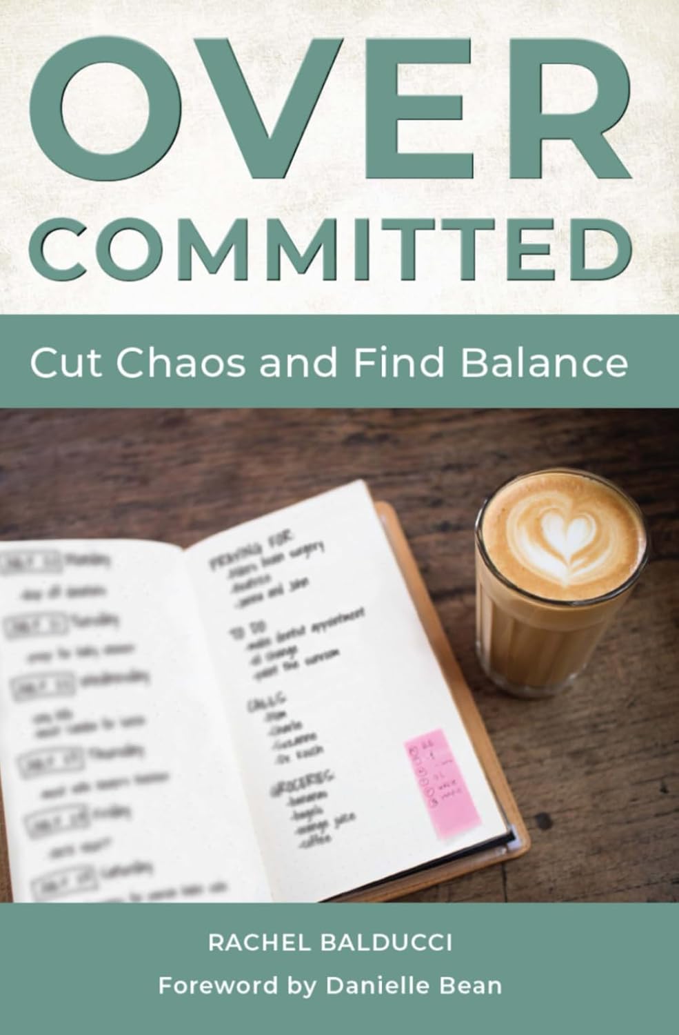Book cover of 'Over-committed' with a notebook and coffee on a wooden surface