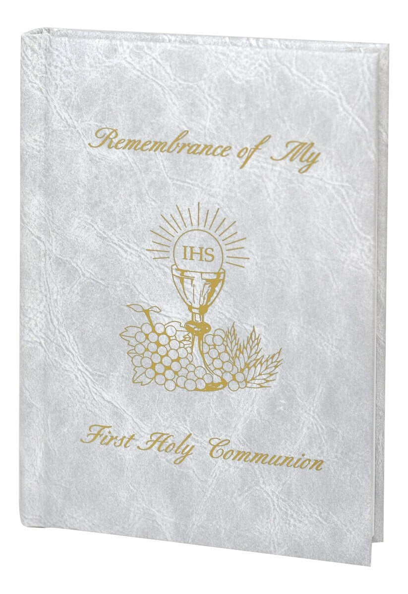 White book with gold text and design, likely for First Holy Communion