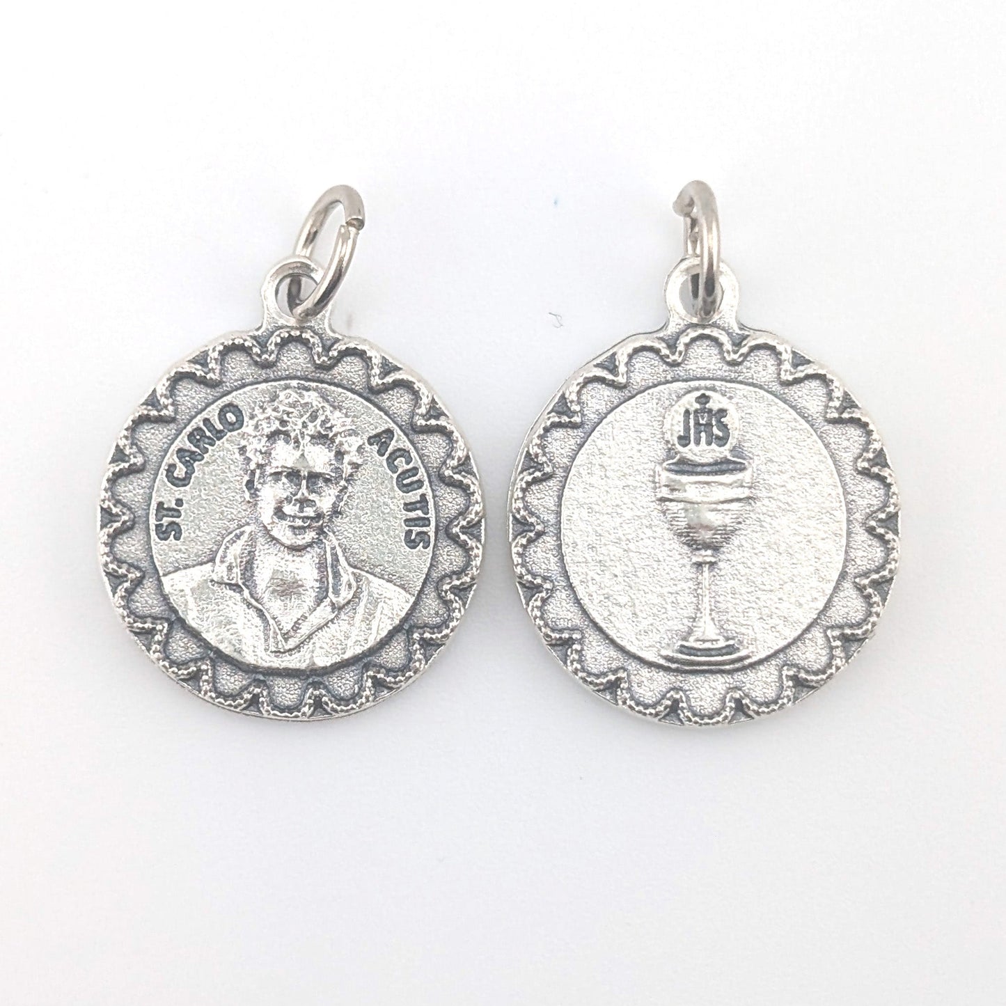 Two silver religious medallions on a white background