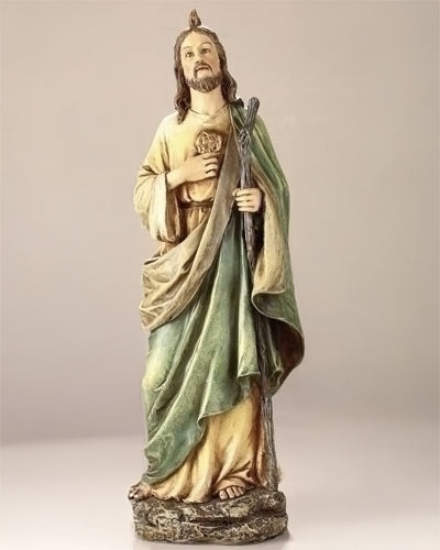 Statue of a religious figure holding a heart and staff on a beige background