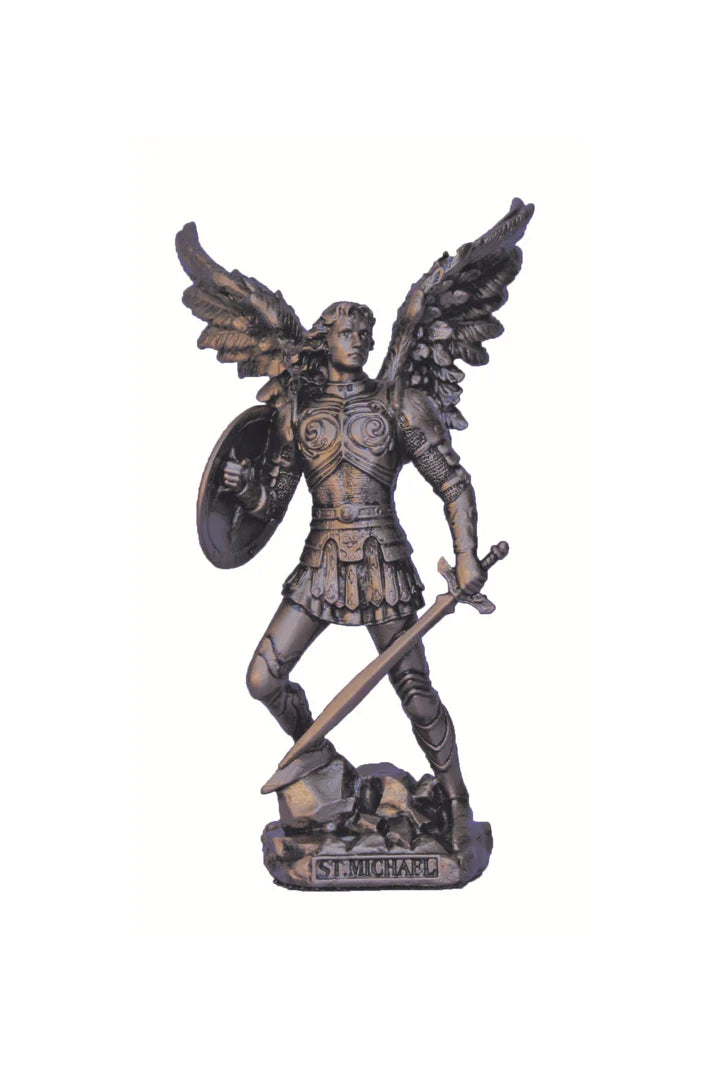 A statue of St. Michael the Archangel without the devil, depicted in a peaceful or victorious stance, holding a sword and a shield, standing on a base with the inscription 'ST.