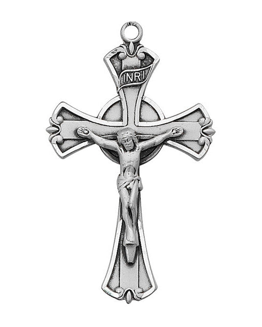 A sterling silver crucifix pendant with intricate detailing on a white background.