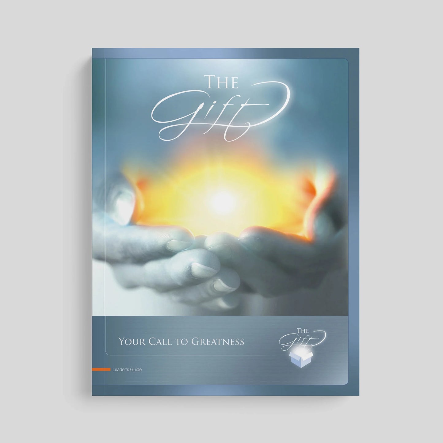 Book cover titled 'The Gift' with hands holding a glowing object on a gray background