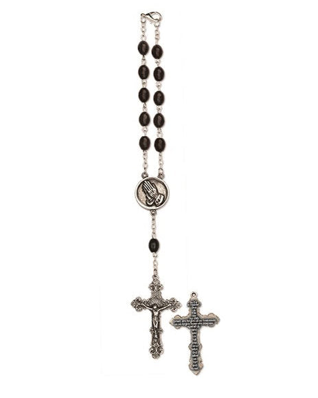 Rosary with black beads and silver crucifixes on a white background