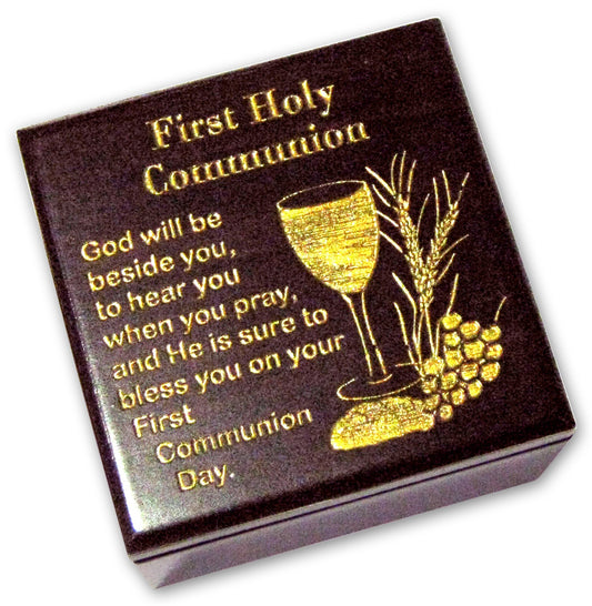 A black wooden keepsake box with gold text and design, commemorating First Holy Communion with a quote and a glass of watercress.