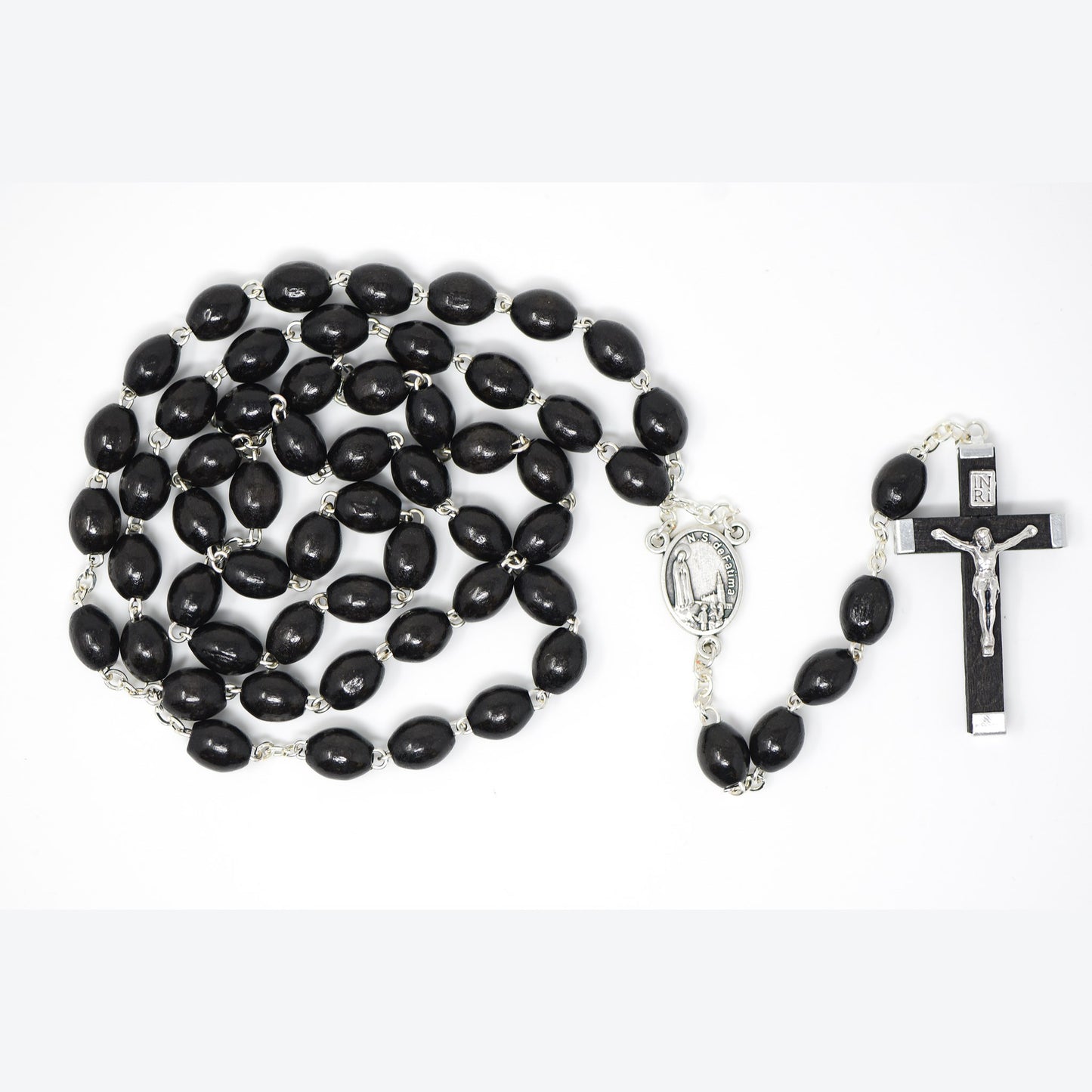 Black rosary beads with silver metal elements on a white background