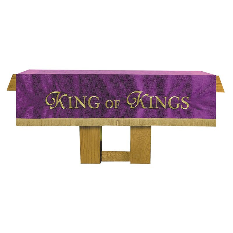 Purple table runner with 'King of Kings' text on a wooden table
