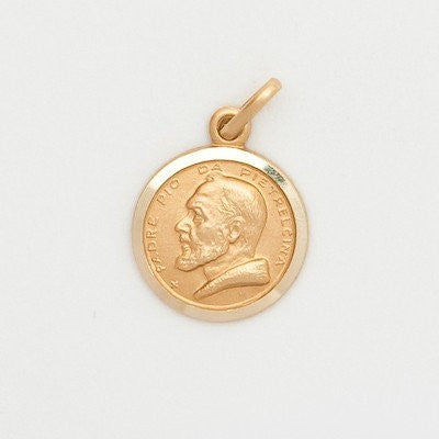 A small round 10K yellow gold medal featuring an image of St. Padre Pio, without a chain, displayed against a white background.