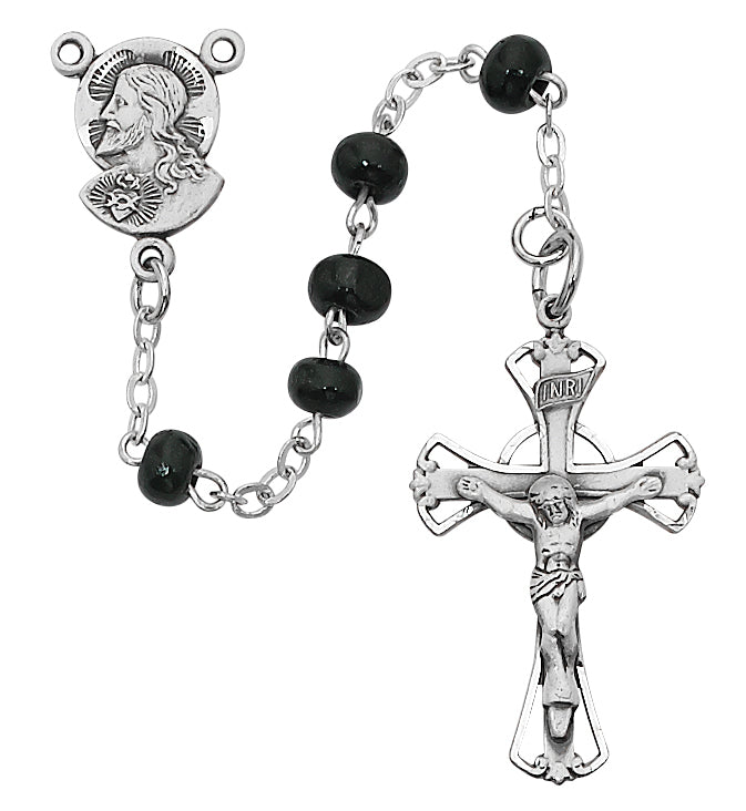 A black wood rosary with silver metallic accents, including a crucifix and a figure of Jesus Christ, displayed against a white background.