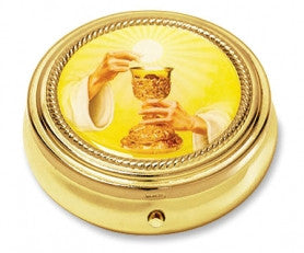 A gold finish chalice pyx with a plastic lined interior, featuring a relief image of a chalice and hosts on the top.