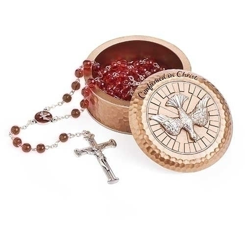 A beige keepsake box with a rosary beads and a silver-colored cross inside. The lid of the box has the inscription 'Confirmed in Christ' and a dove symbol.