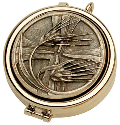 A nickel plated wheat and cross design on the lid of a pyx, with a visible hinge and locking mechanism.