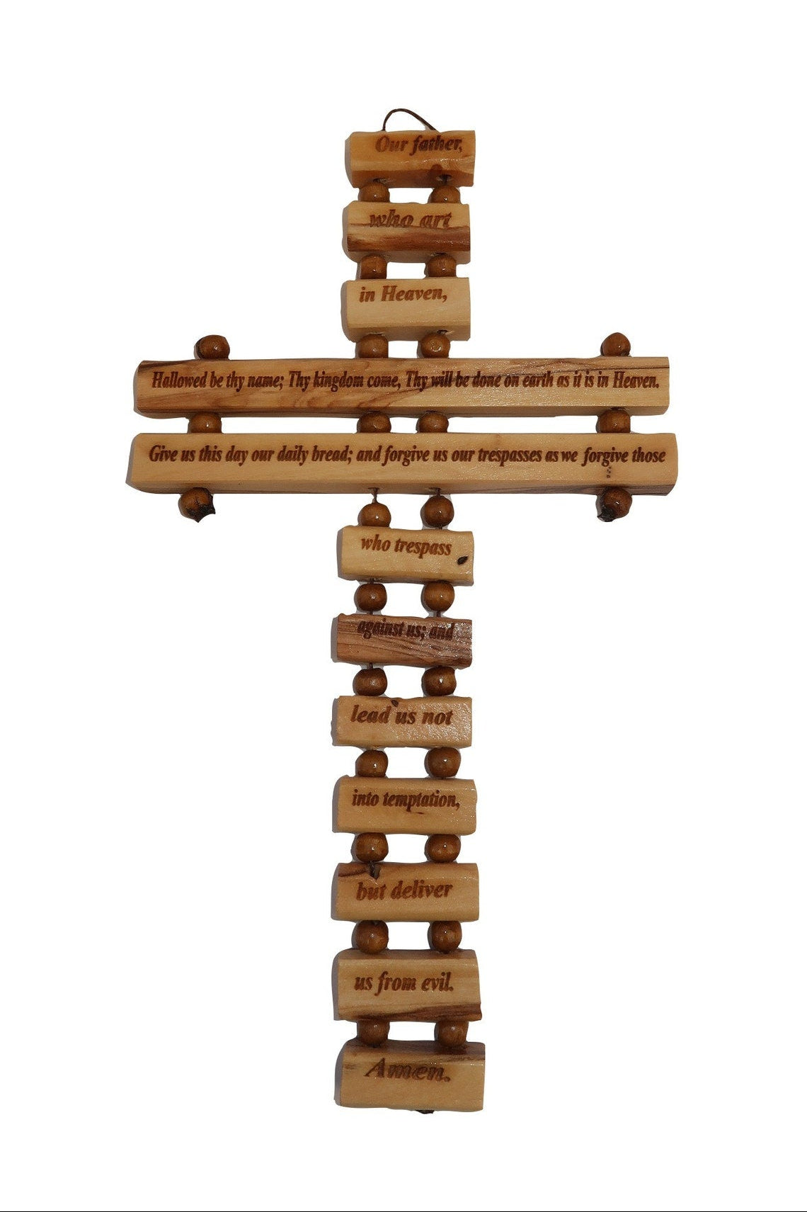 A wall-mounted olive wood cross with 'Our Father' prayer written in various languages.