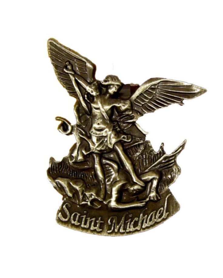 A metal St. Michael car visor clip with an embossed image of the archangel on a pewter-like finish.