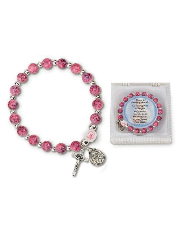 A pink glass memorial teardrop bracelet with a silver-tone clasp, alongside a pink card with a message.