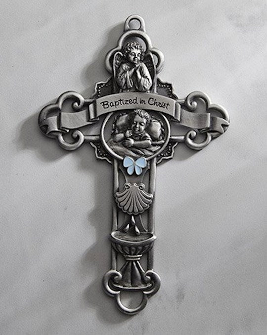A silver-colored baptism cross with a blue enamelled bow in the centre and the words 'Baptized in Christ' inscribed on it. The cross has intricate hand-sculpted details.