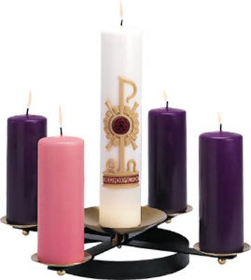A black wrought iron advent wreath with spikes for holding candles, featuring brass bobeches. Pillar candles are inserted in the holder, with one white and three purple candles lit.