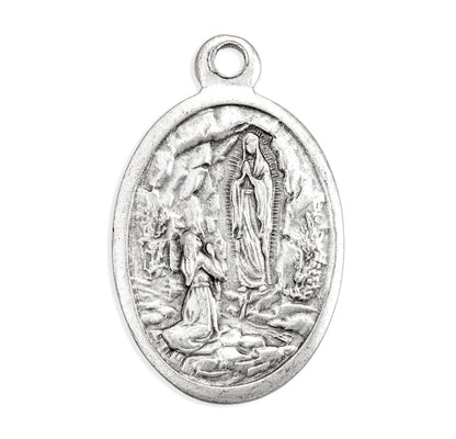 Silver pendant with religious design on a white background
