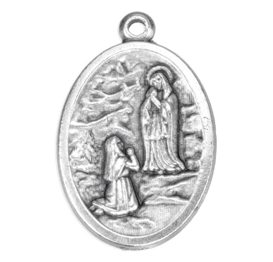 Silver pendant with religious design on a white background