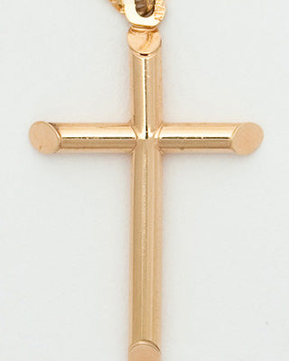 Gold cross pendant on a white background