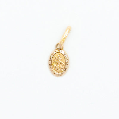 Gold pendant with a religious design on a white background