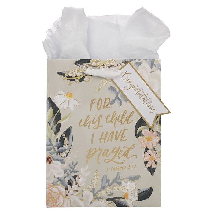Gift bag with floral design and 'Congratulations' tag on a white background