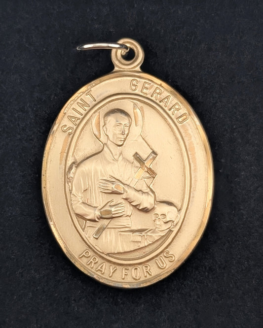 Gold Saint Gerard medal on a black background