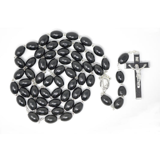 Black rosary beads with a crucifix on a white background