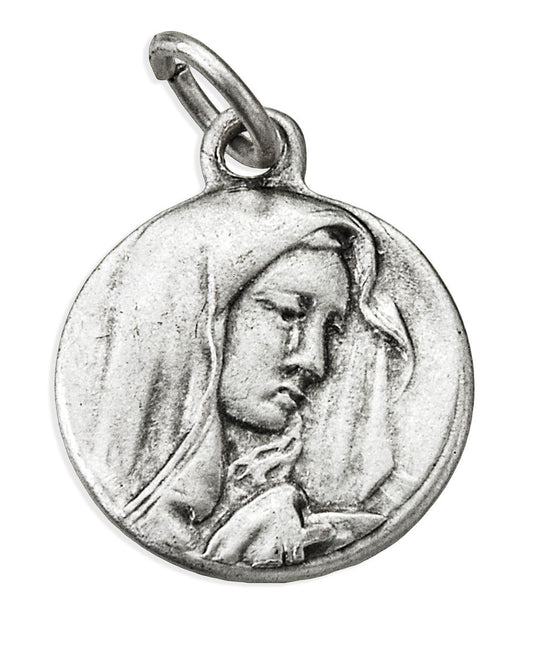 A round silver-toned metal pendant charm featuring an embossed profile of the Virgin Mary, with a small top loop for attachment, shown on a plain white background.