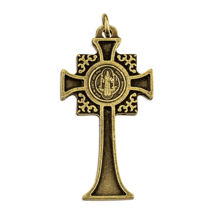 An antique bronze cross pendant featuring a central circular medallion of the Virgin Mary and ornate scrollwork on the cross arms, shown against a plain white background.